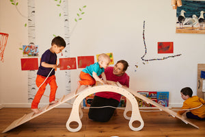 children playing on the good wood rocker with slider 