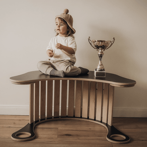 little girl sittin on the tabletop rocker good wood