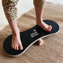 Load image into Gallery viewer, A GIRL BALANCING ON THE BLACK BALANCE BOARD / TRICK BOARD FOR KIDS- GOOD WOOD