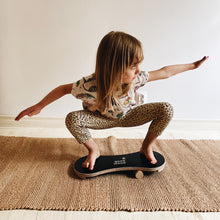 Load image into Gallery viewer, A GIRL HAVING FUN ON THE BLACK BALANCE BOARD / TRICK BOARD FOR KIDS- GOOD WOOD