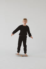 Load image into Gallery viewer, A BOY BALANCING ON THE GREY BALANCE BOARD / TRICK BOARD FOR KIDS- GOOD WOOD