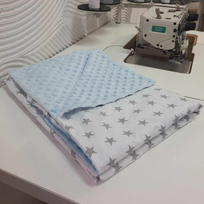 grey stars on the white cotton weighted blanket with baby blue minky backing