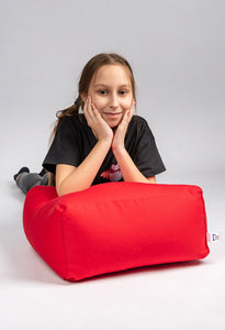 GIRL LEANING UPON RED COTTON SQUARE POUF